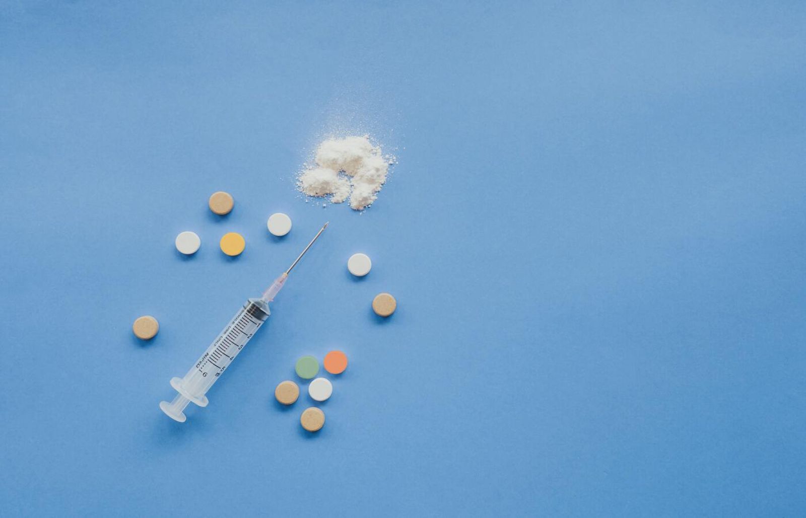 Picture of a syringe and pills banner image