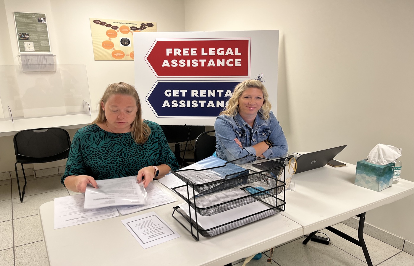 two ladies sitting at eviction diversion check-in desk