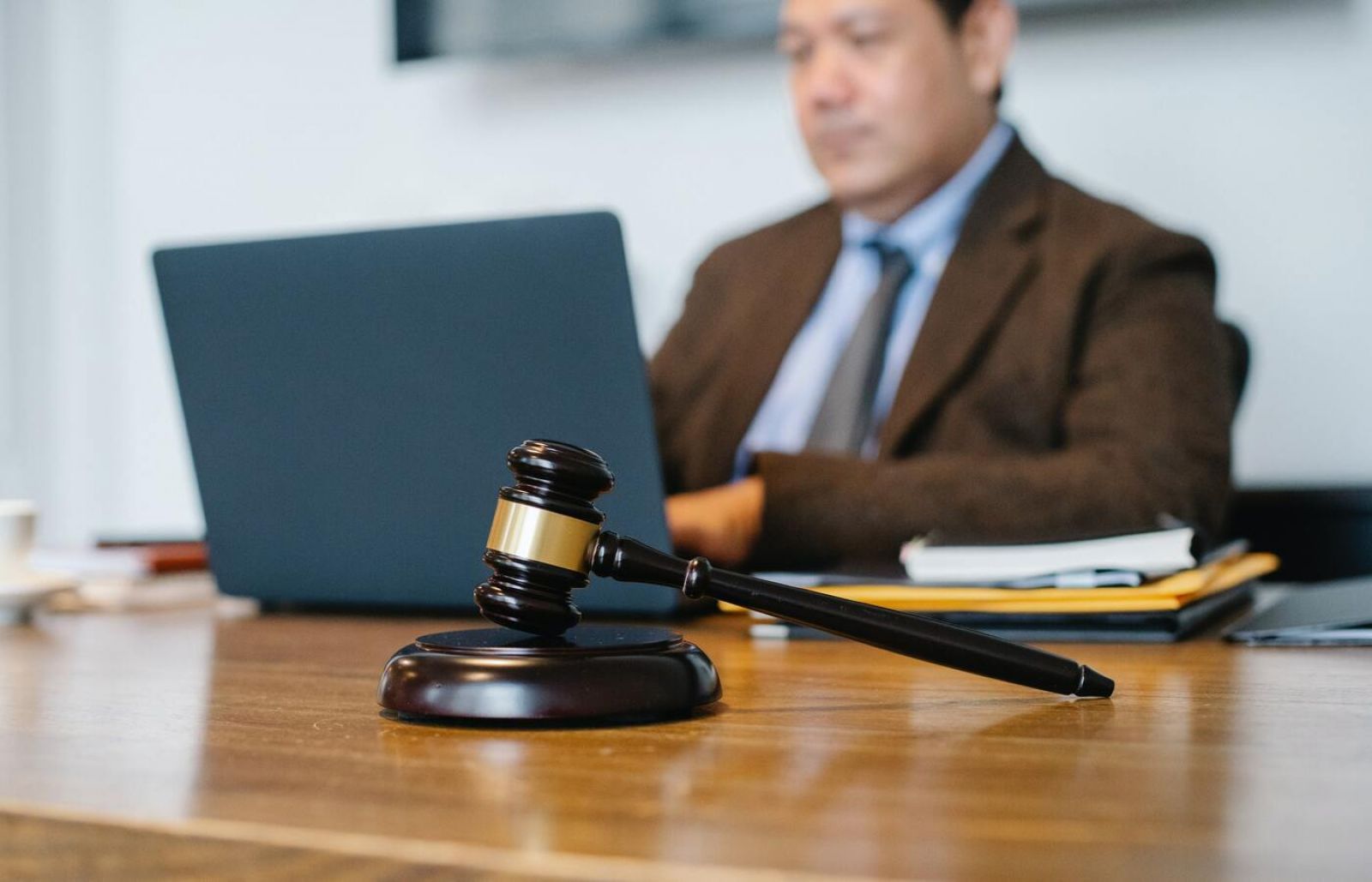 Image: court gavel and man on a laptop banner image
