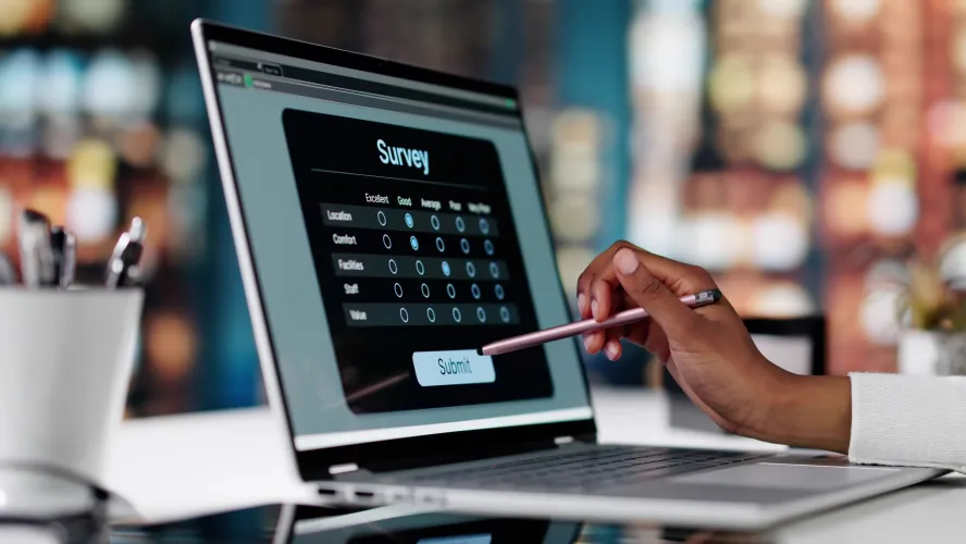 Person completing online survey on laptop