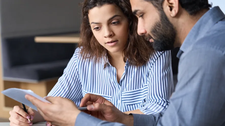 man and woman looking at a document