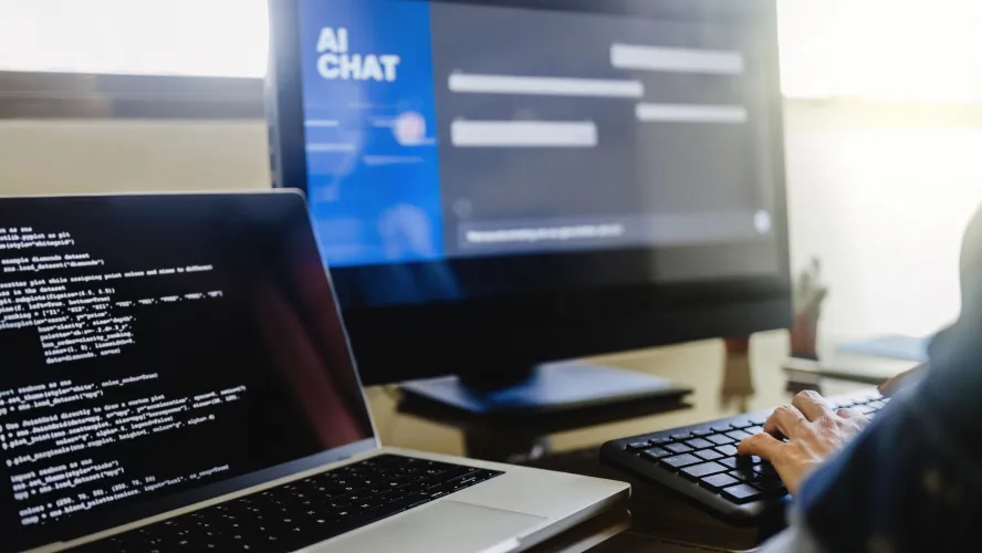 photo of computer monitors & AI chat window