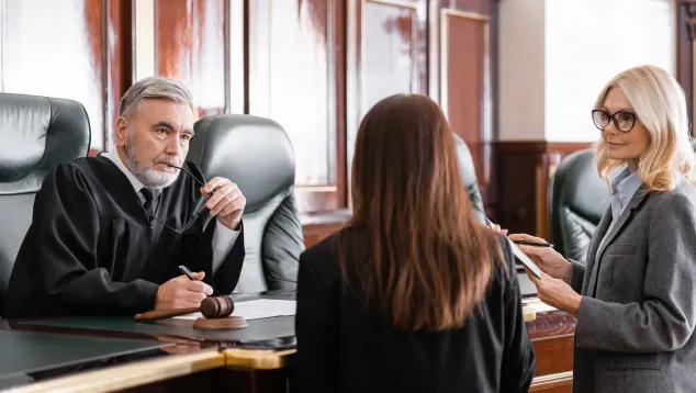 Judge and attorneys discussion at bench in the courtroom