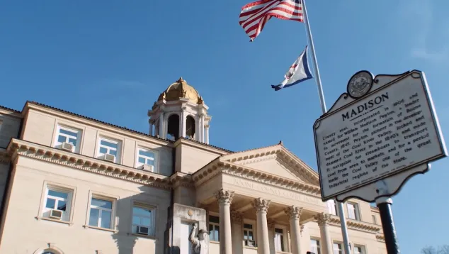 Boone County Courthouse with Madison historical sign and flags