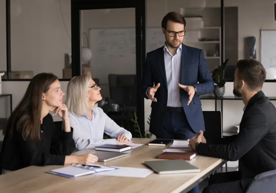 Business professionals in meeting, man presenting ideas.