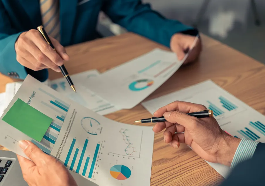 People reviewing charts and graphs in business meeting