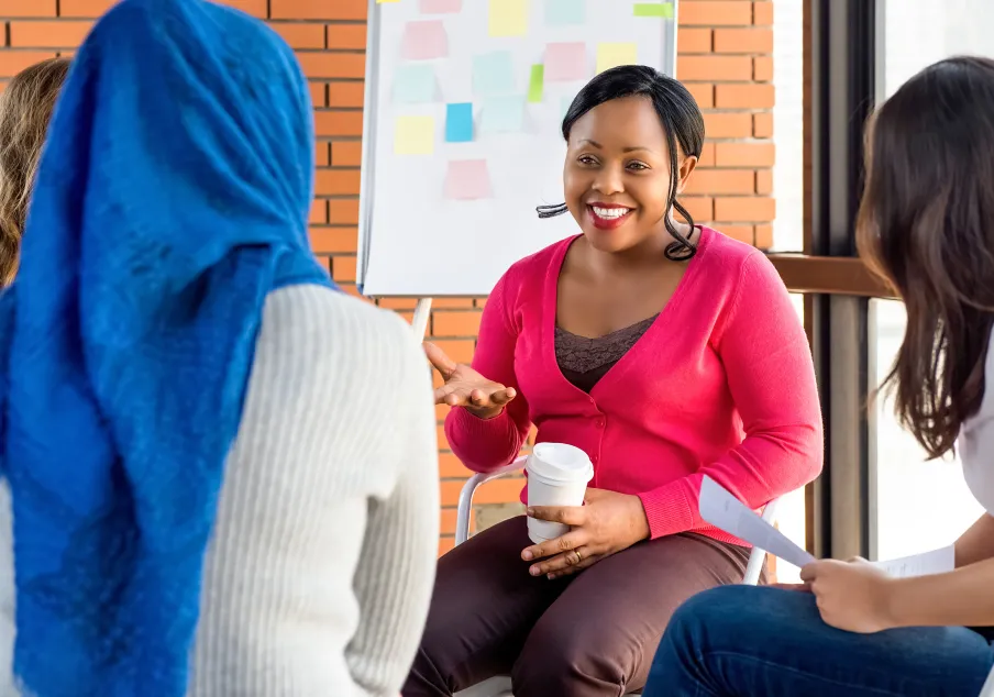 A woman speaking with people in a group