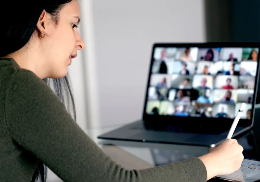 A woman on laptop attending virtual call