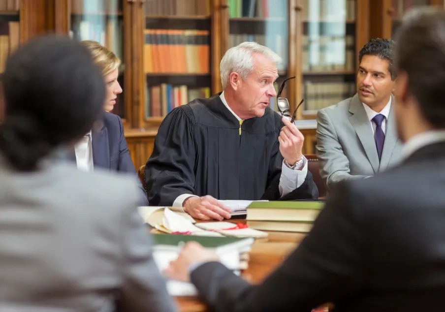 Judge leading legal discussion with diverse courtroom team