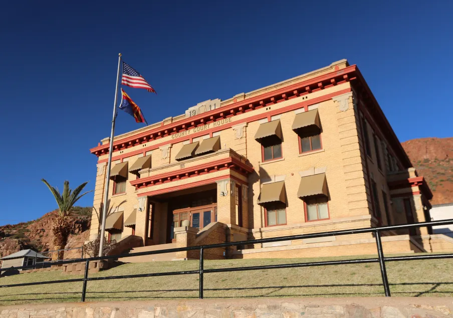 Historic county courthouse building with flags flying