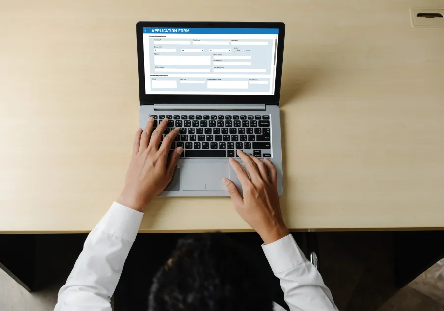 A person registerting for a class on a laptop computer.