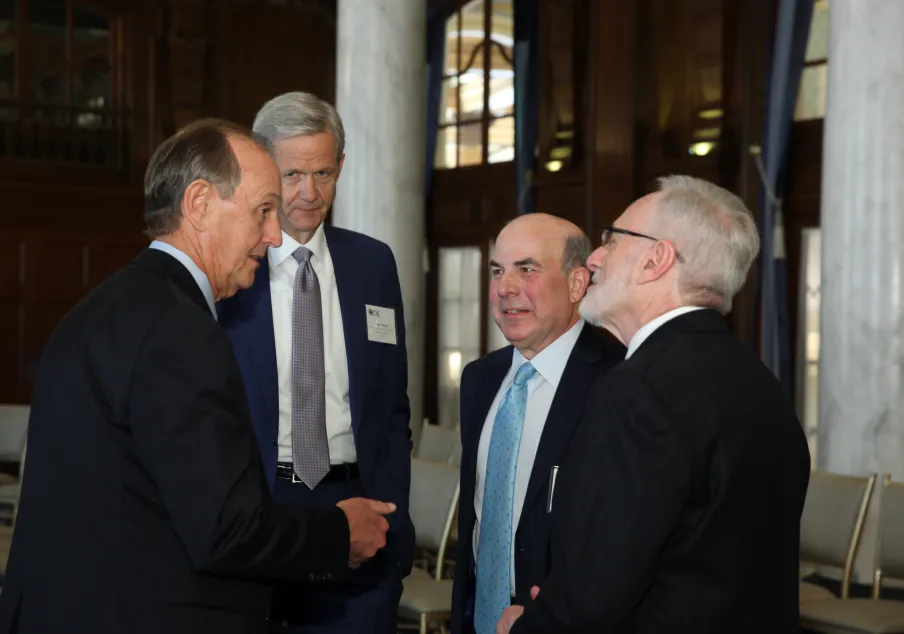 A group of chief justices talking at a conference.