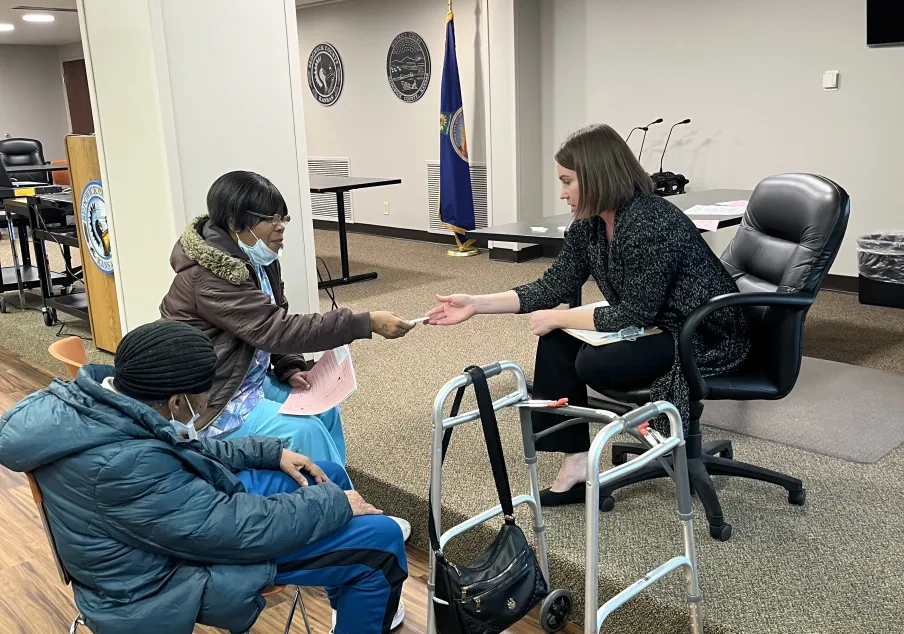 Court staff assisting elderly individuals in community setting