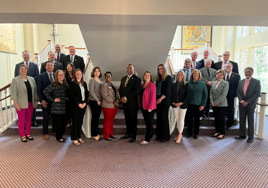 Diverse group of professionals posing on staircase indoors