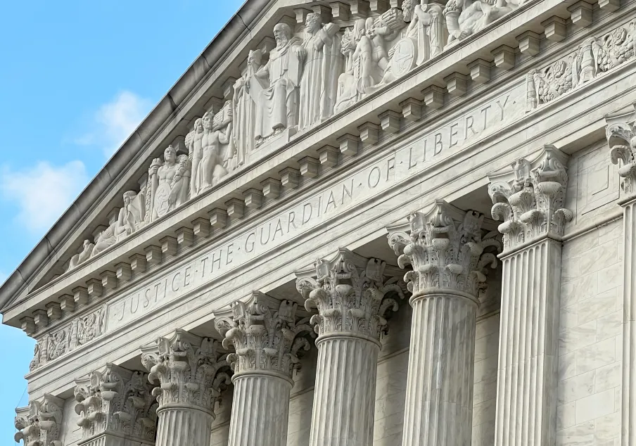 “Guardian of Liberty” etched into the upper facade of a courthouse.