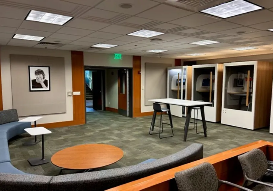 Modern office lounge with seating and phone booths