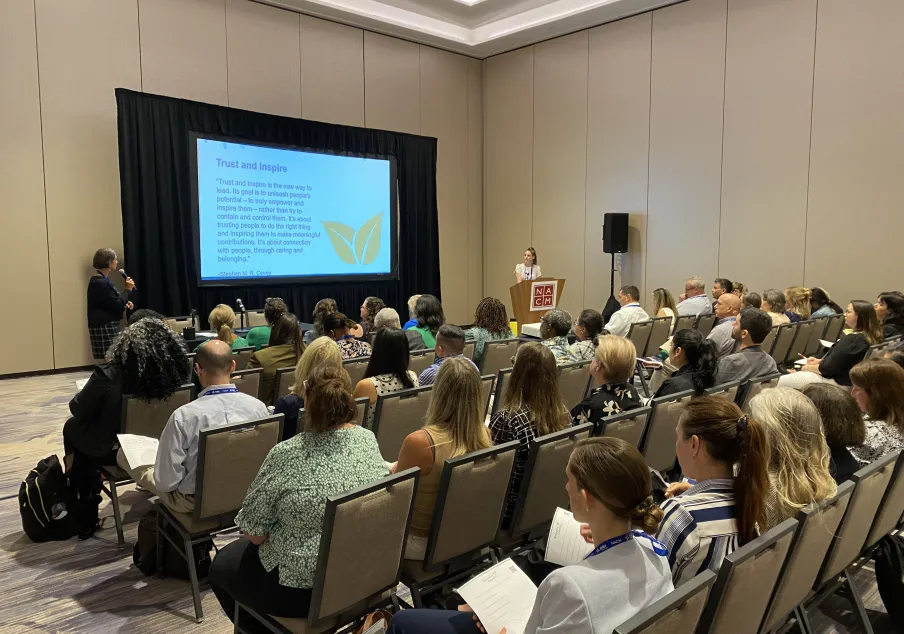Audience listening to a presentation on leadership and inspiration