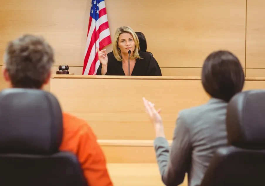 Female judge listening to people in courtroom session