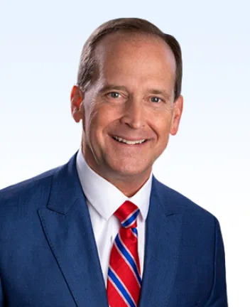 Professional headshot of man in suit and tie