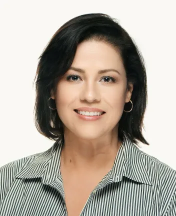 Professional woman with short dark hair and striped shirt