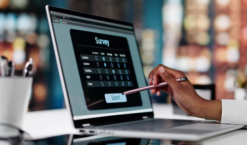 Person completing online survey on laptop