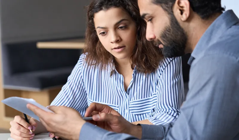 man and woman looking at a document