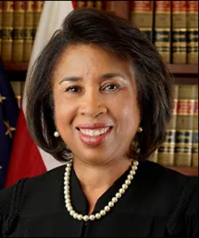 African American female judge smiling in courtroom setting